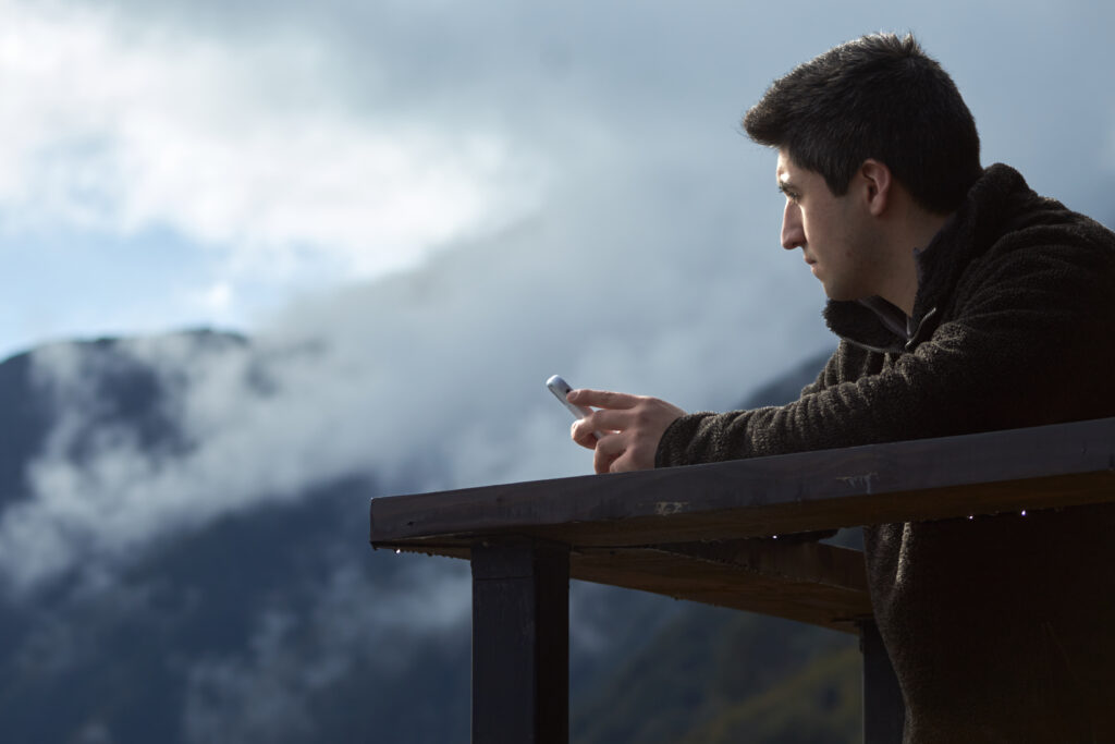 Shallow focus shot of a young male using his smartphone
